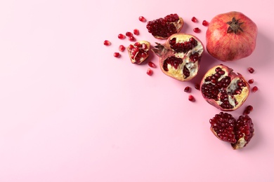 Photo of Composition with ripe pomegranates and space for text on color background, top view