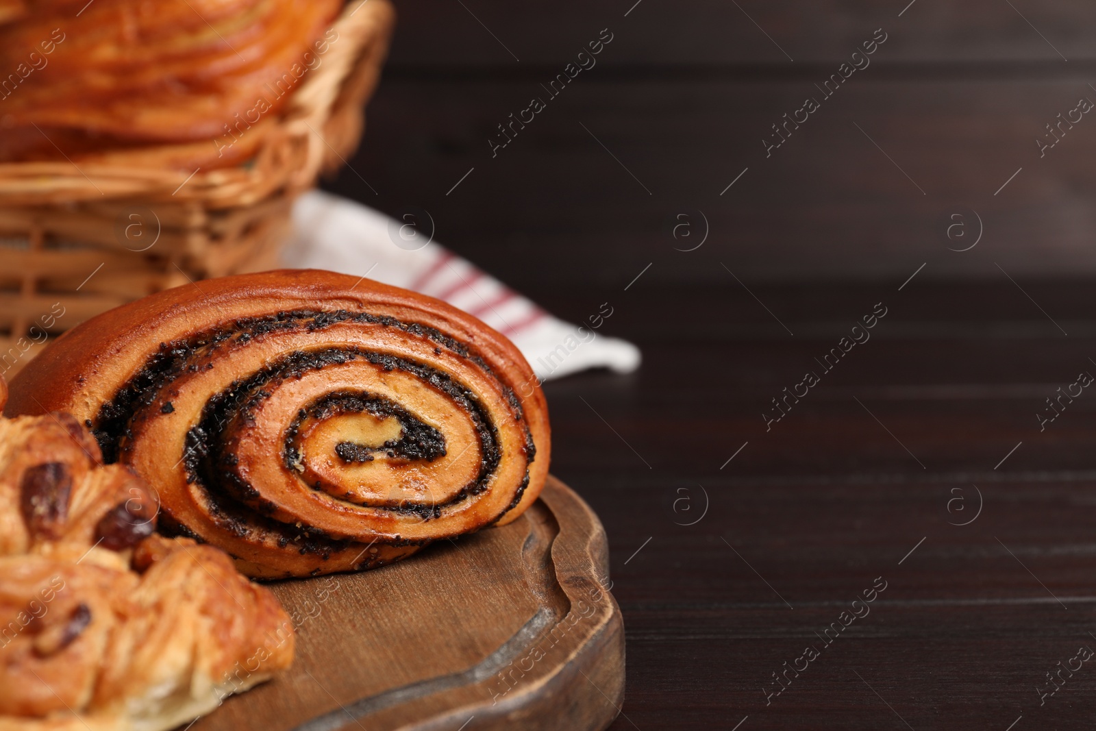 Photo of Different tasty freshly baked pastries on wooden table, closeup. Space for text