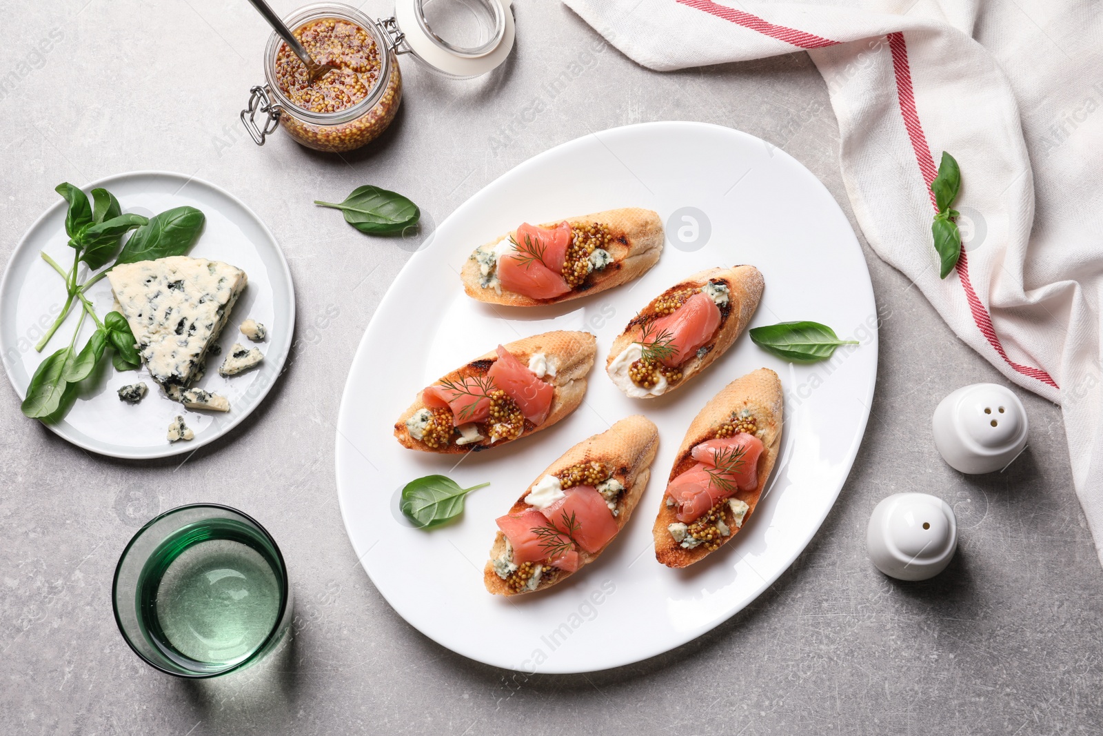 Photo of Flat lay composition with tasty bruschettas on grey table