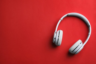 Photo of Wireless headphones on color background, top view. Space for text