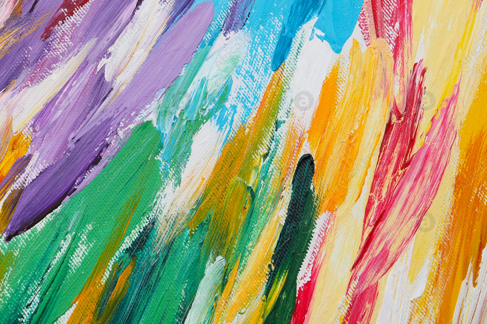 Photo of Beautiful strokes of colorful oil paints on white canvas as background, closeup