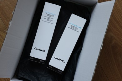 NETHERLANDS, LEIDEN - JULY 12, 2022: Chanel micellar water and micro liquid essence in box on wooden table, top view