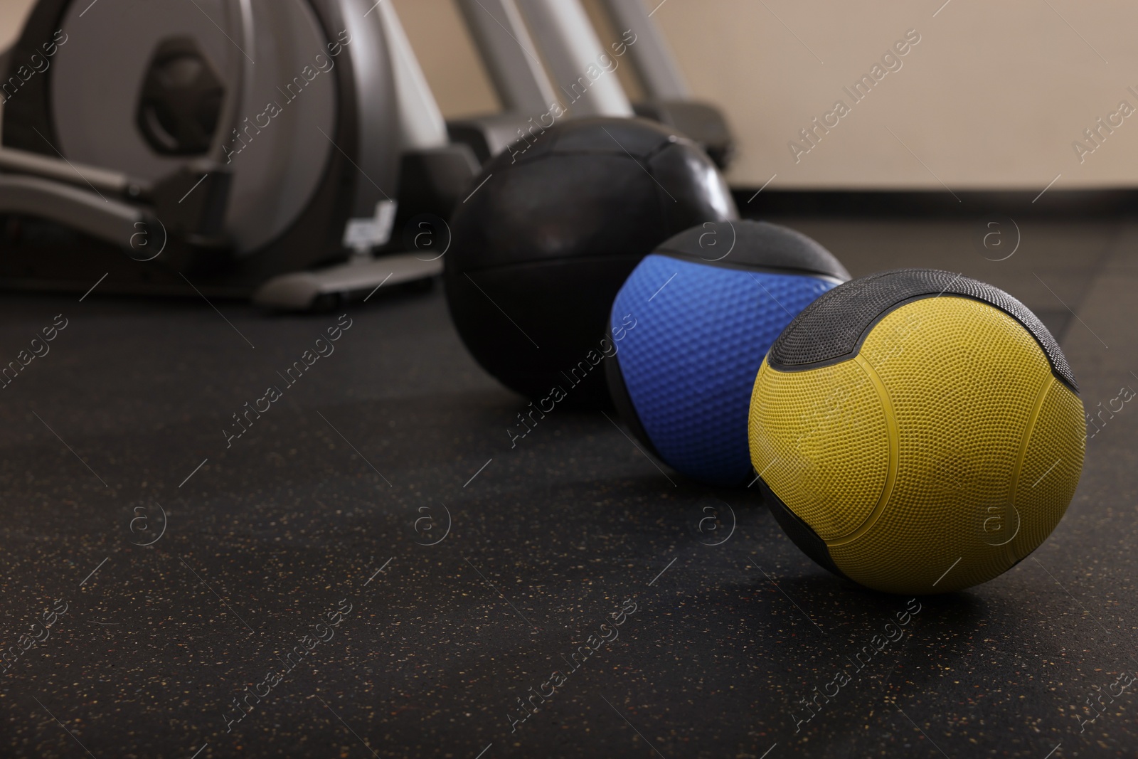 Photo of Medicine balls on floor in gym, space for text