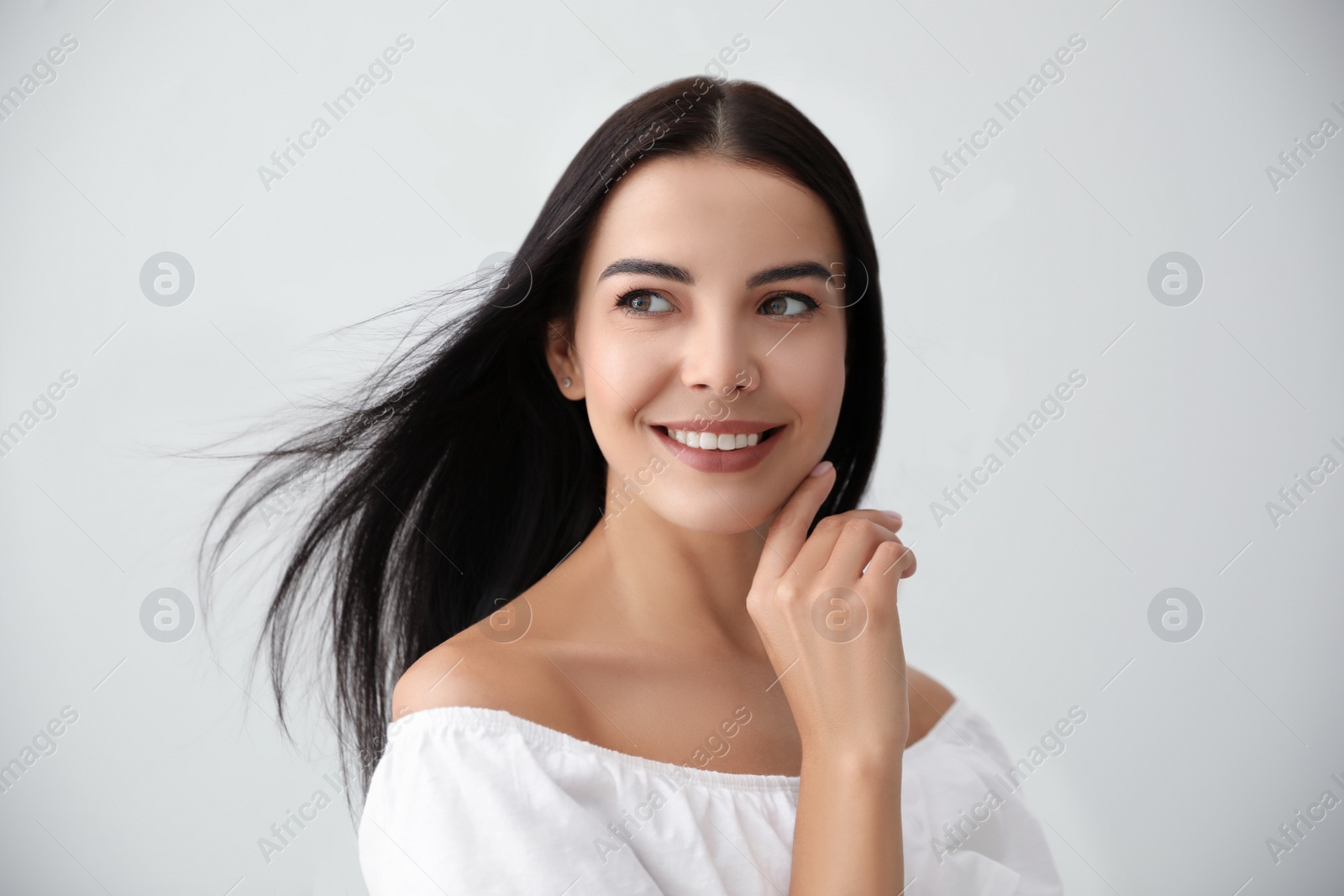 Photo of Beautiful young woman on light grey background