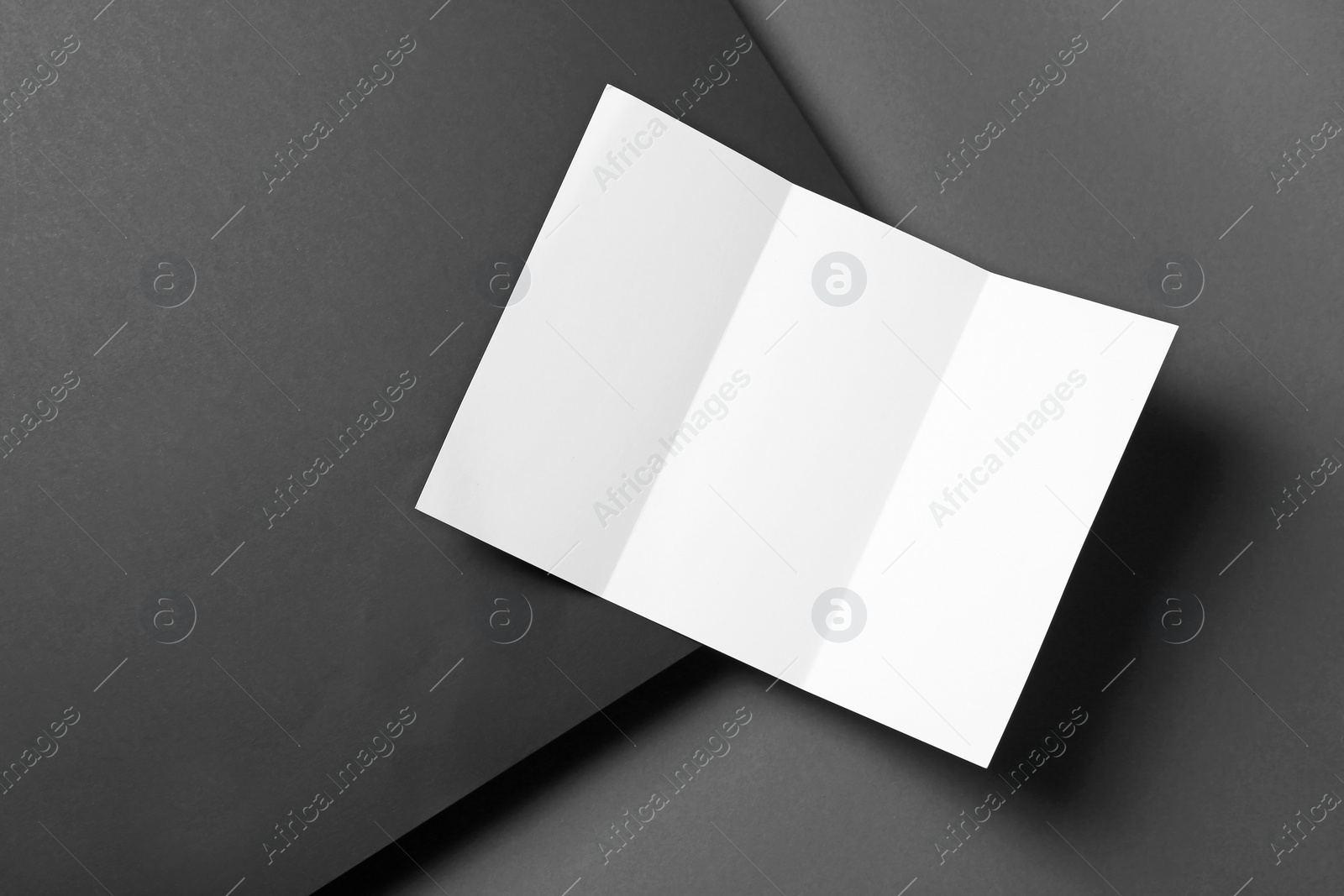 Photo of Empty flyer on dark background. Mockup for design