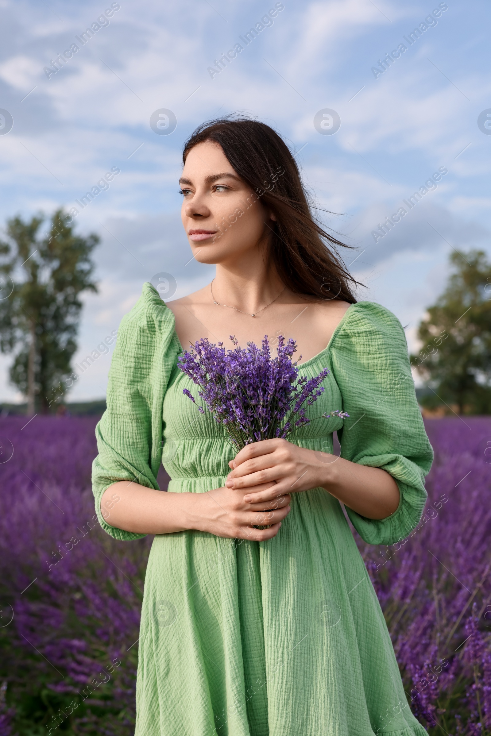 Photo of Beautiful woman with bouquet in lavender field