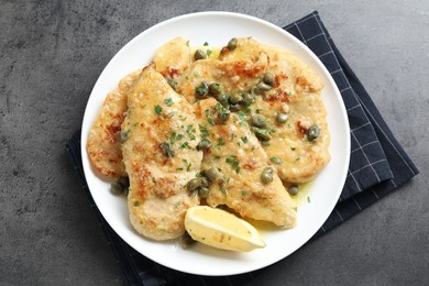 Delicious chicken piccata with herbs on grey table, top view