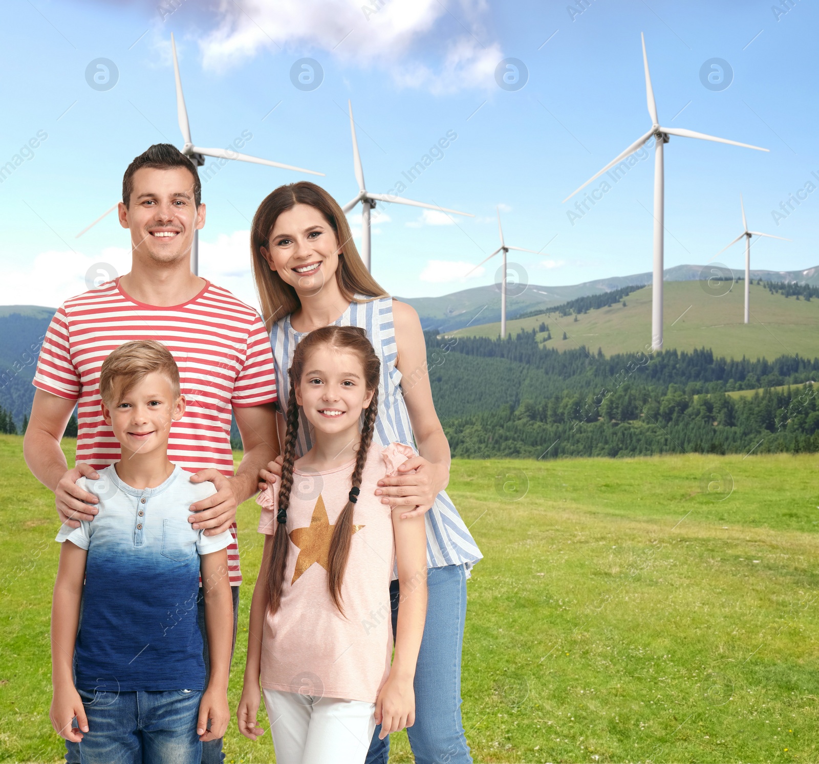 Image of Happy family with children and view of wind energy turbines on sunny day