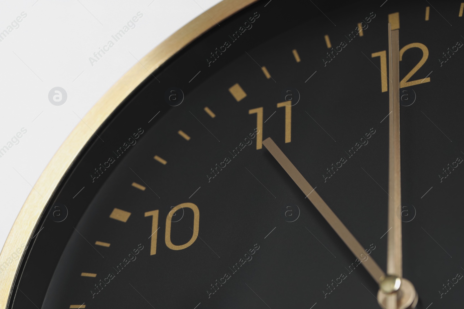 Photo of Stylish round clock on white background, closeup. Interior element
