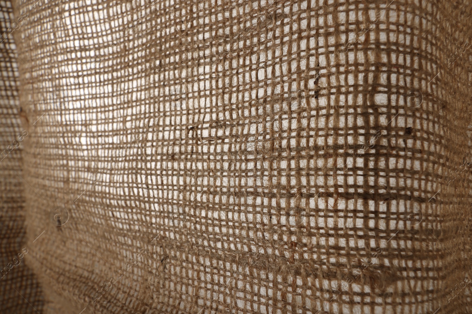 Photo of Texture of natural burlap fabric as background, closeup