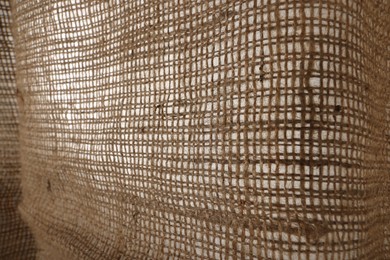 Photo of Texture of natural burlap fabric as background, closeup