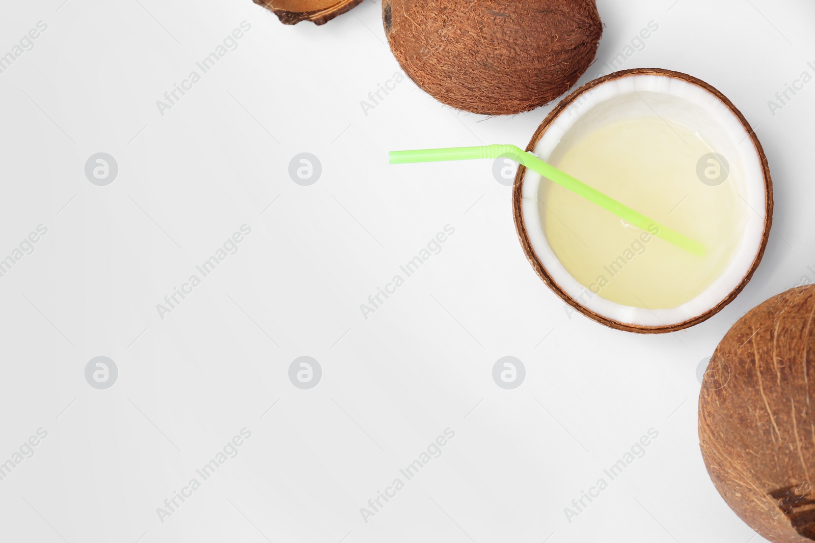 Photo of Composition with drink in half of coconut on white background, top view