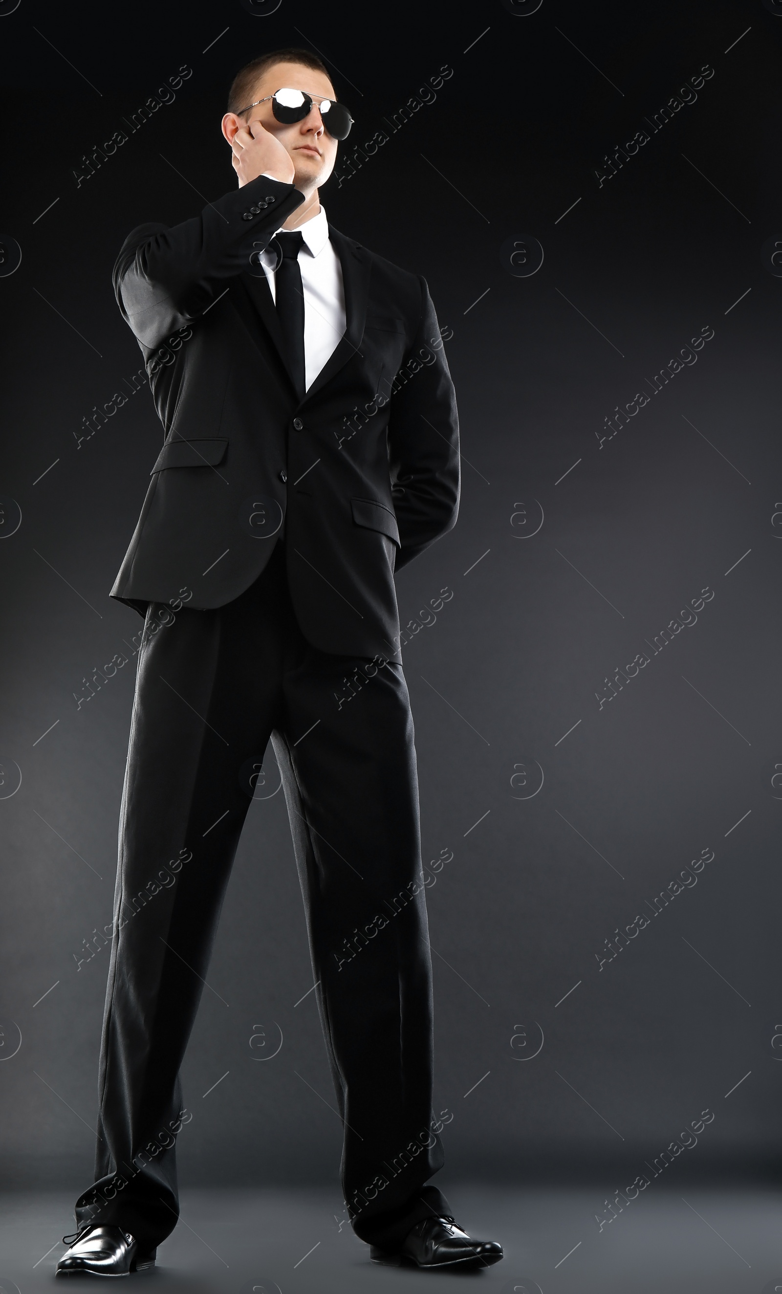 Photo of Male security guard in uniform on dark background