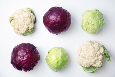 Flat lay composition with ripe cabbages on white background