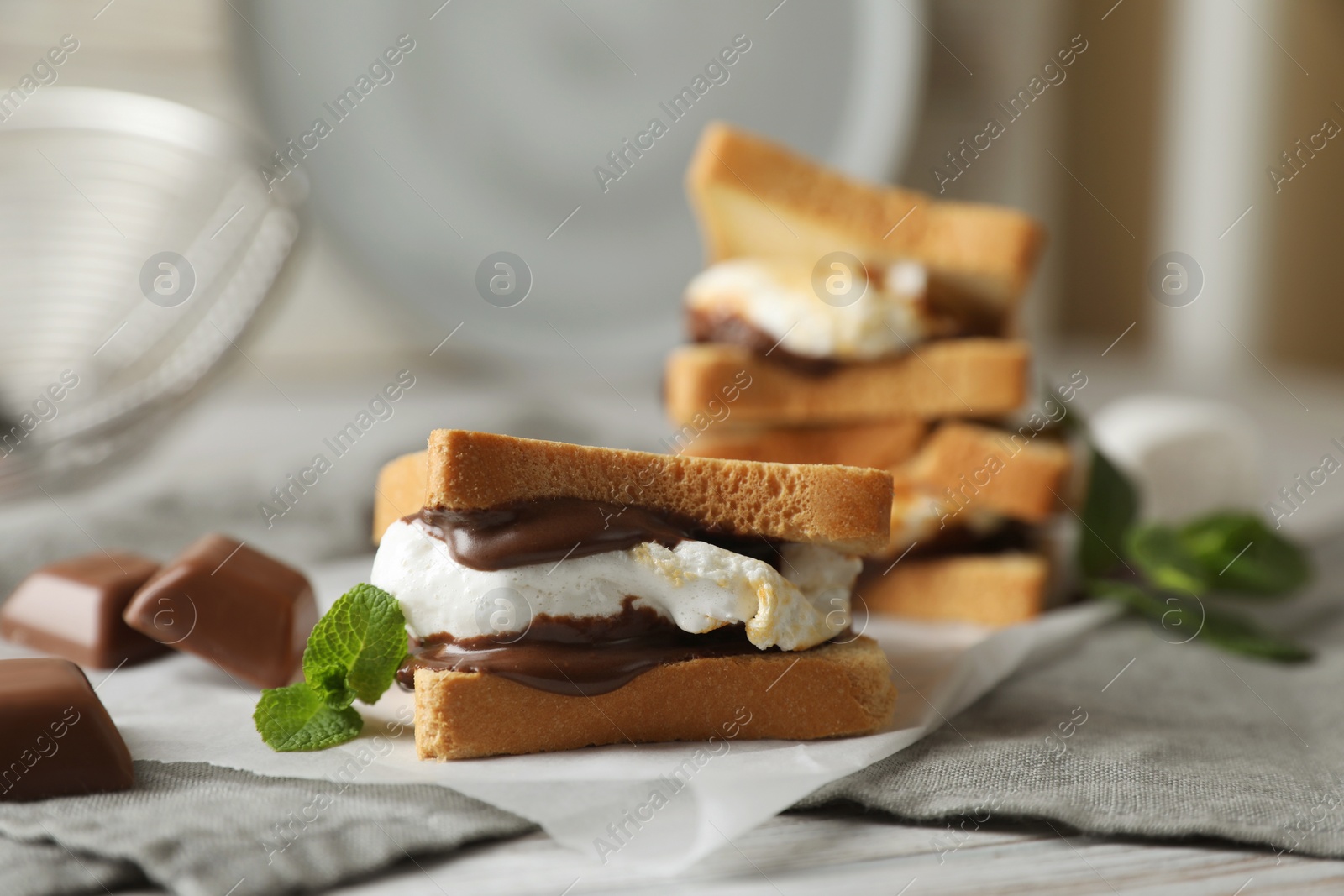 Photo of Delicious marshmallow sandwich with bread and chocolate on white wooden table, closeup