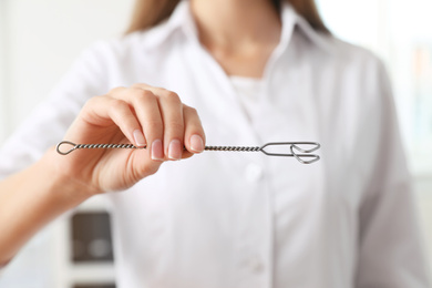 Speech therapist with logopedic probe in clinic, closeup