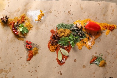 Photo of World map of different spices and products on table, top view