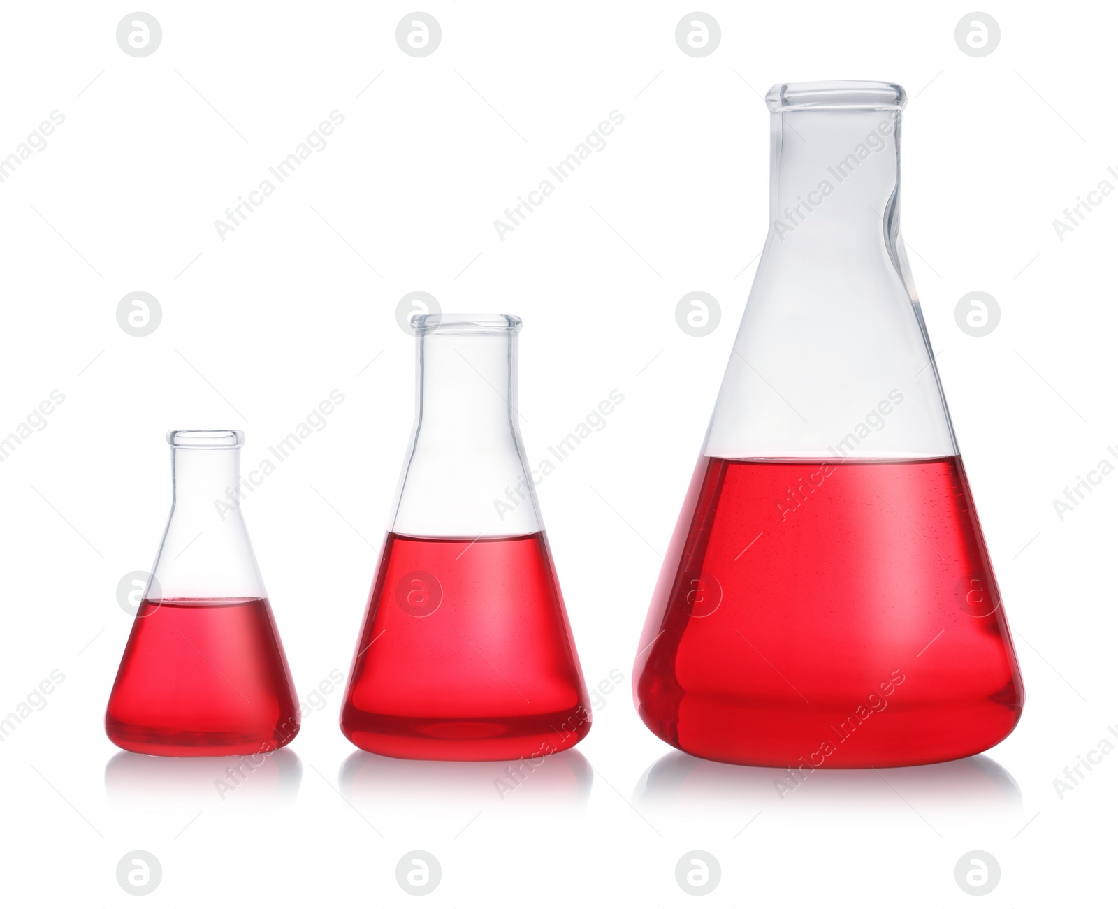 Photo of Conical flasks with red liquid on white background. Laboratory glassware