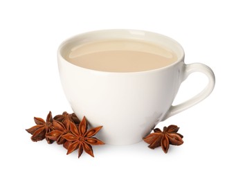 Photo of Cup of tea with milk and anise stars on white background