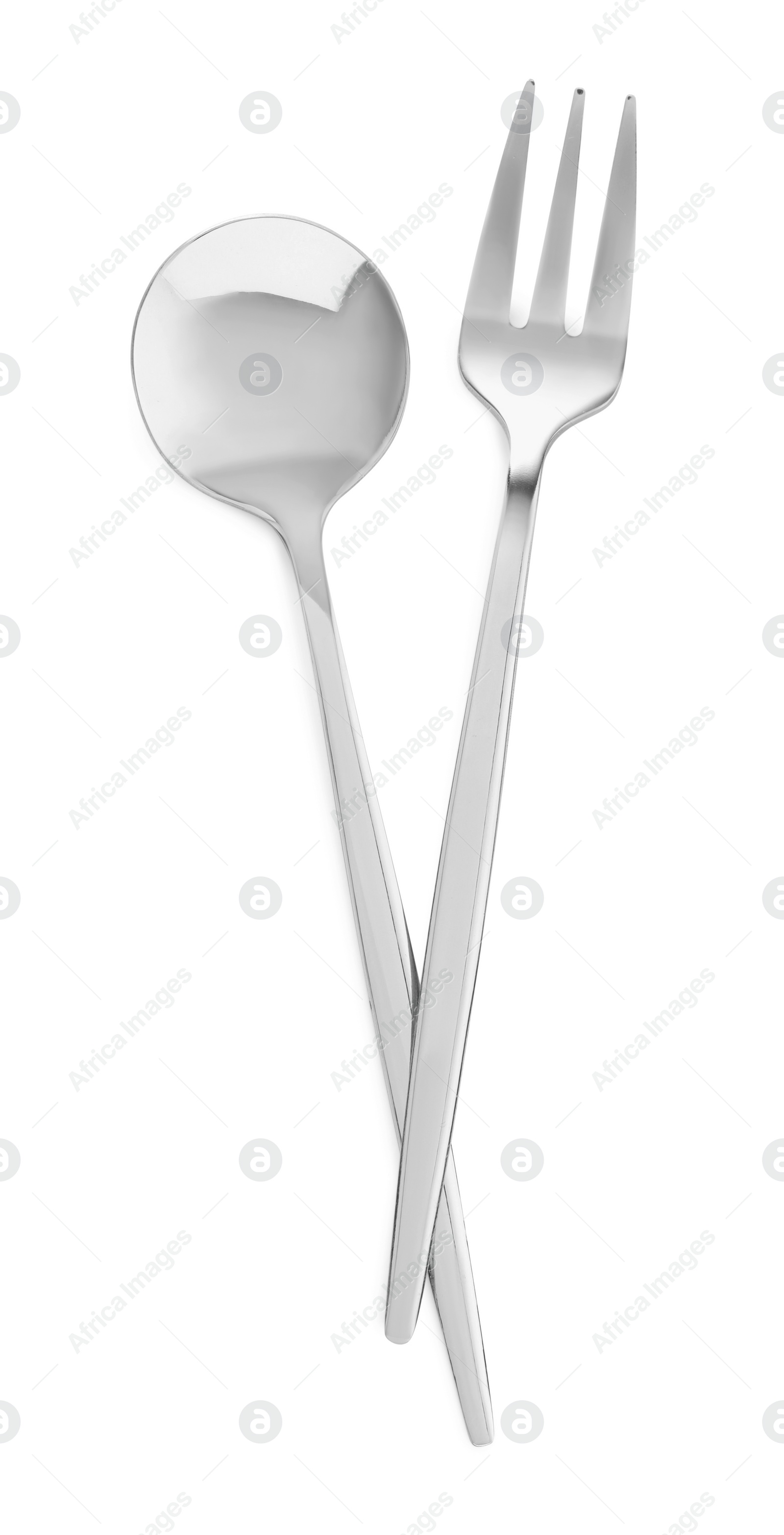 Photo of Spoon and fork isolated on white, top view. Stylish shiny cutlery set