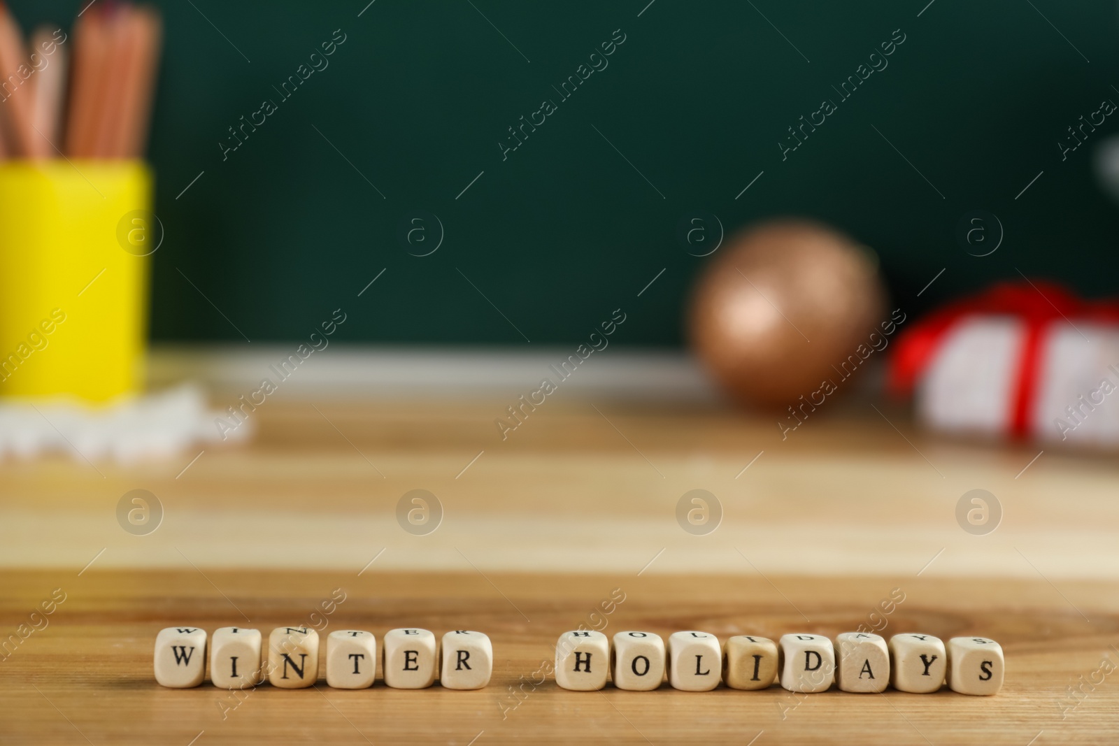 Photo of Wooden cubes with phrase Winter Holidays on table. Space for text