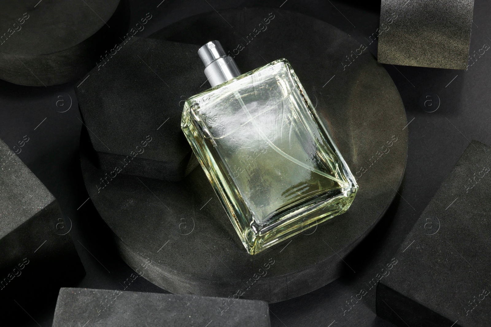 Photo of Stylish presentation of luxury men`s perfume in bottle on black background