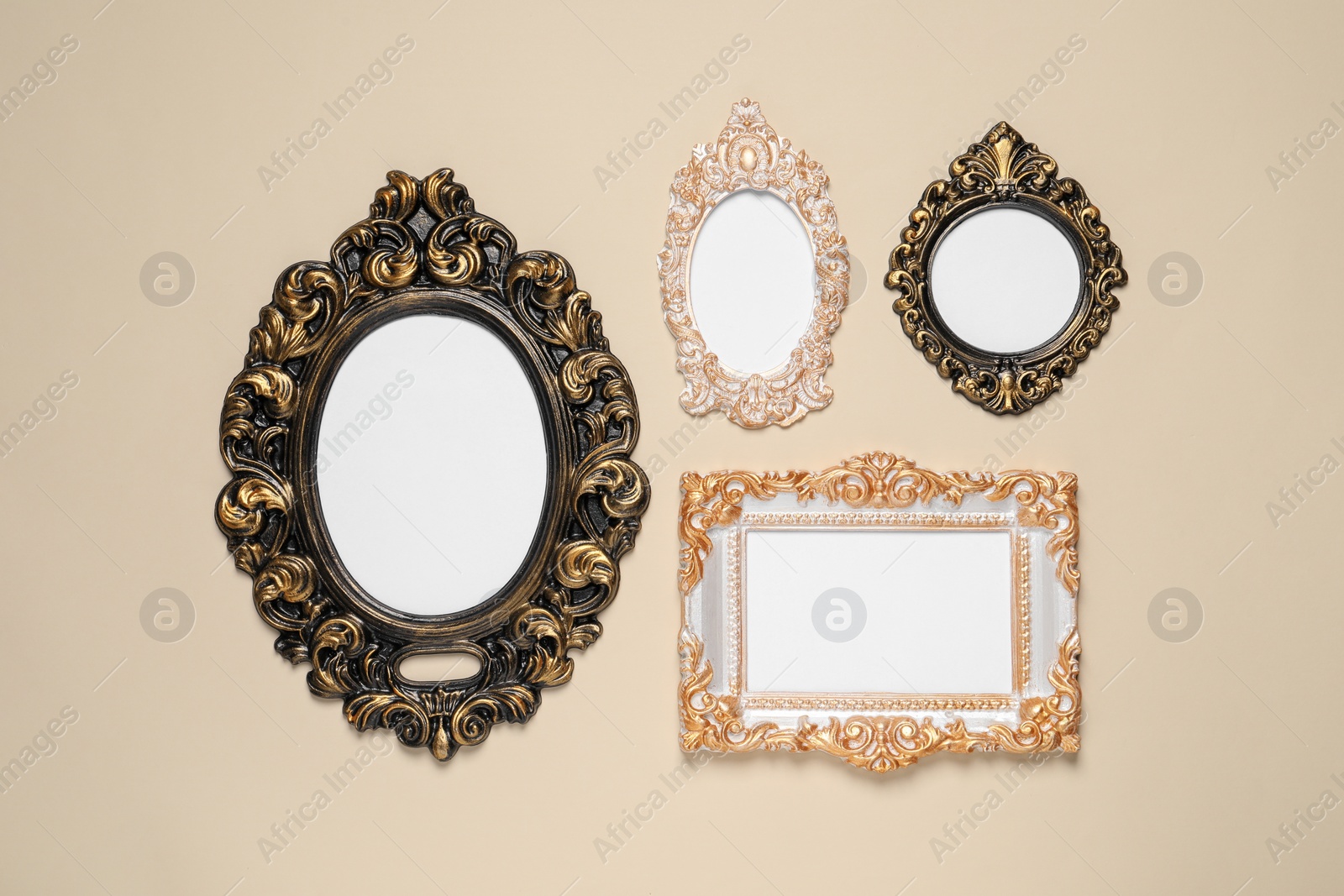 Photo of Empty vintage frames hanging on beige wall