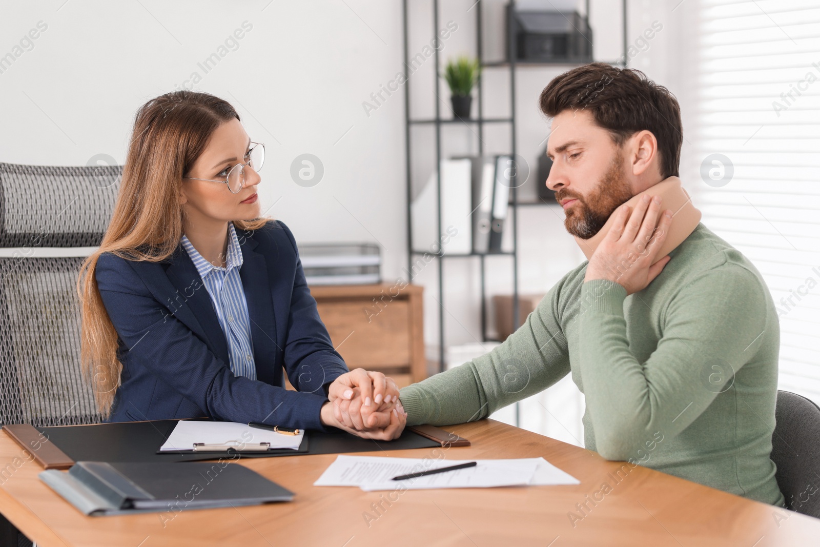 Photo of Injured man having meeting with lawyer in office