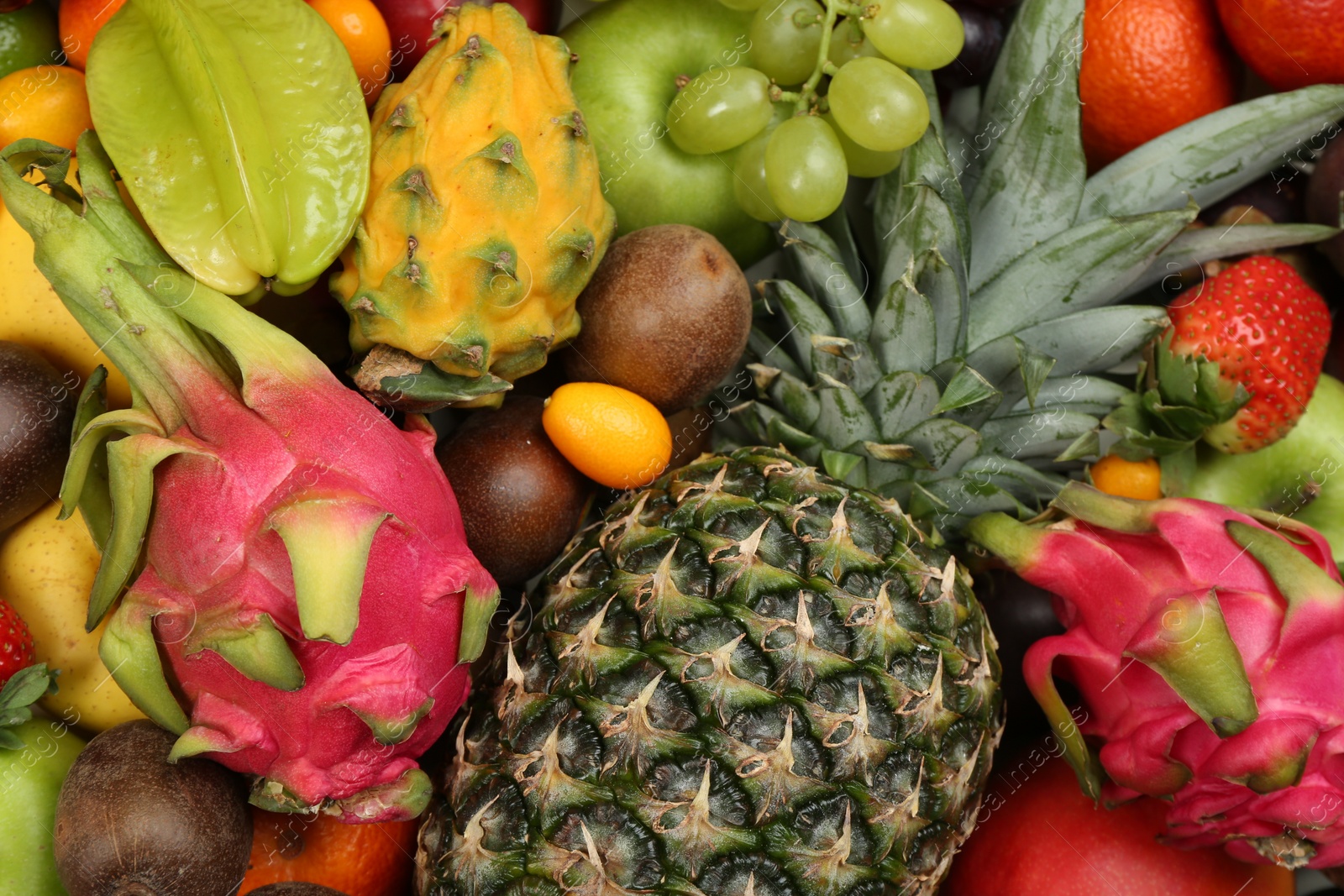 Photo of Assortment of fresh exotic fruits as background, top view