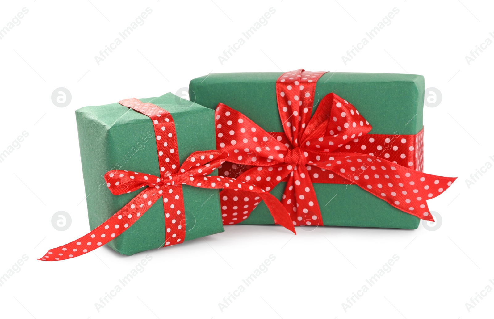 Photo of Christmas gift boxes decorated with red bows on white background