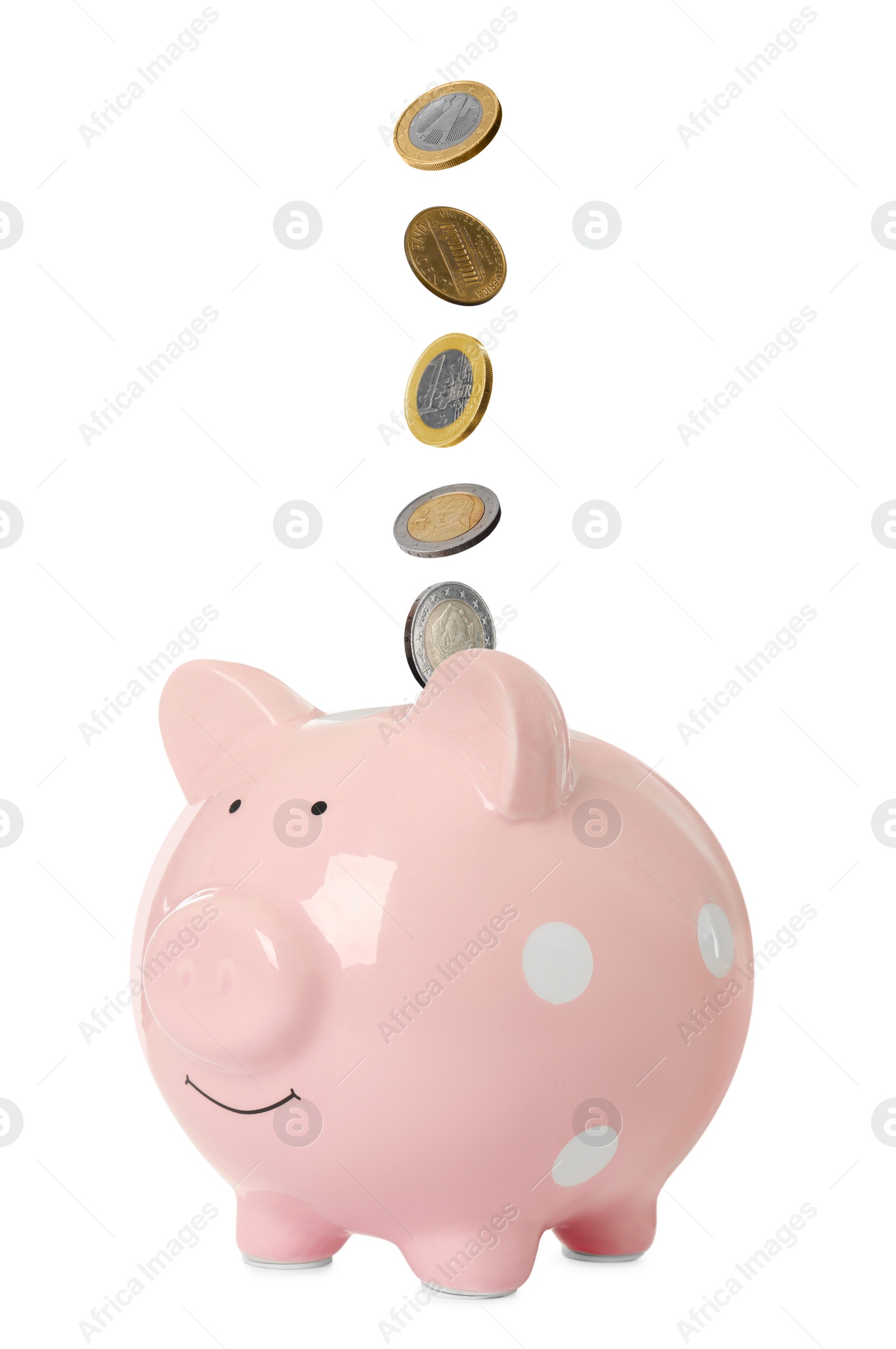 Image of Money falling into pink piggy bank on white background