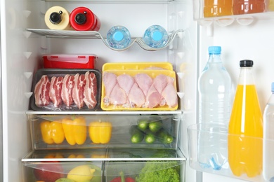 Open refrigerator with many different products, closeup