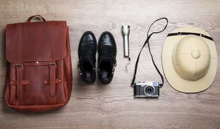 Photo of Flat lay composition with different safari accessories on wooden background