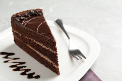 Piece of tasty chocolate cake served on plate