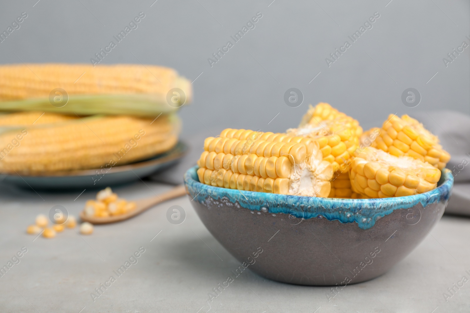 Photo of Bowl with tasty sweet corn on table