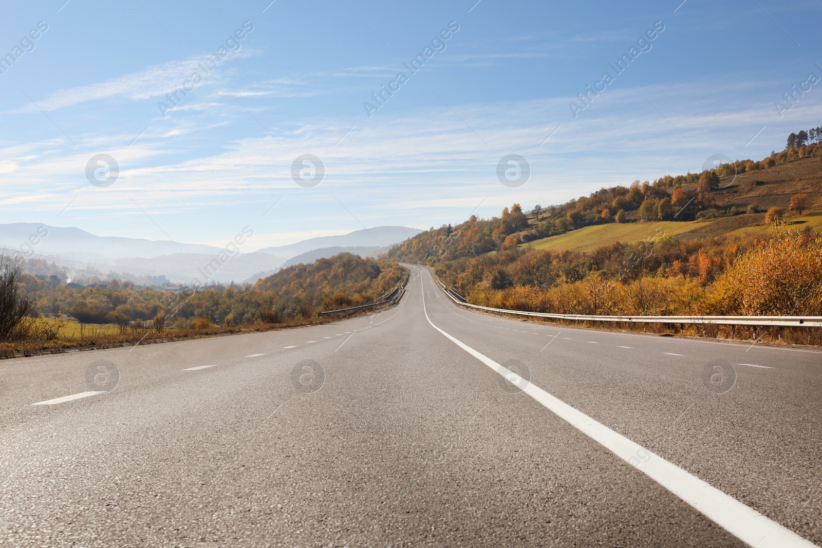 Photo of Landscape with asphalt road leading to mountains