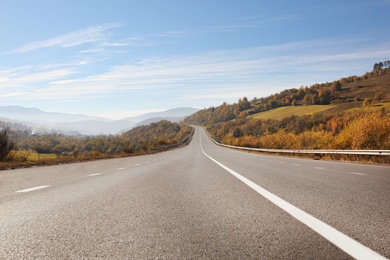 Photo of Landscape with asphalt road leading to mountains