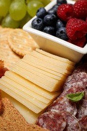Photo of Snack set with delicious Parmesan cheese, closeup