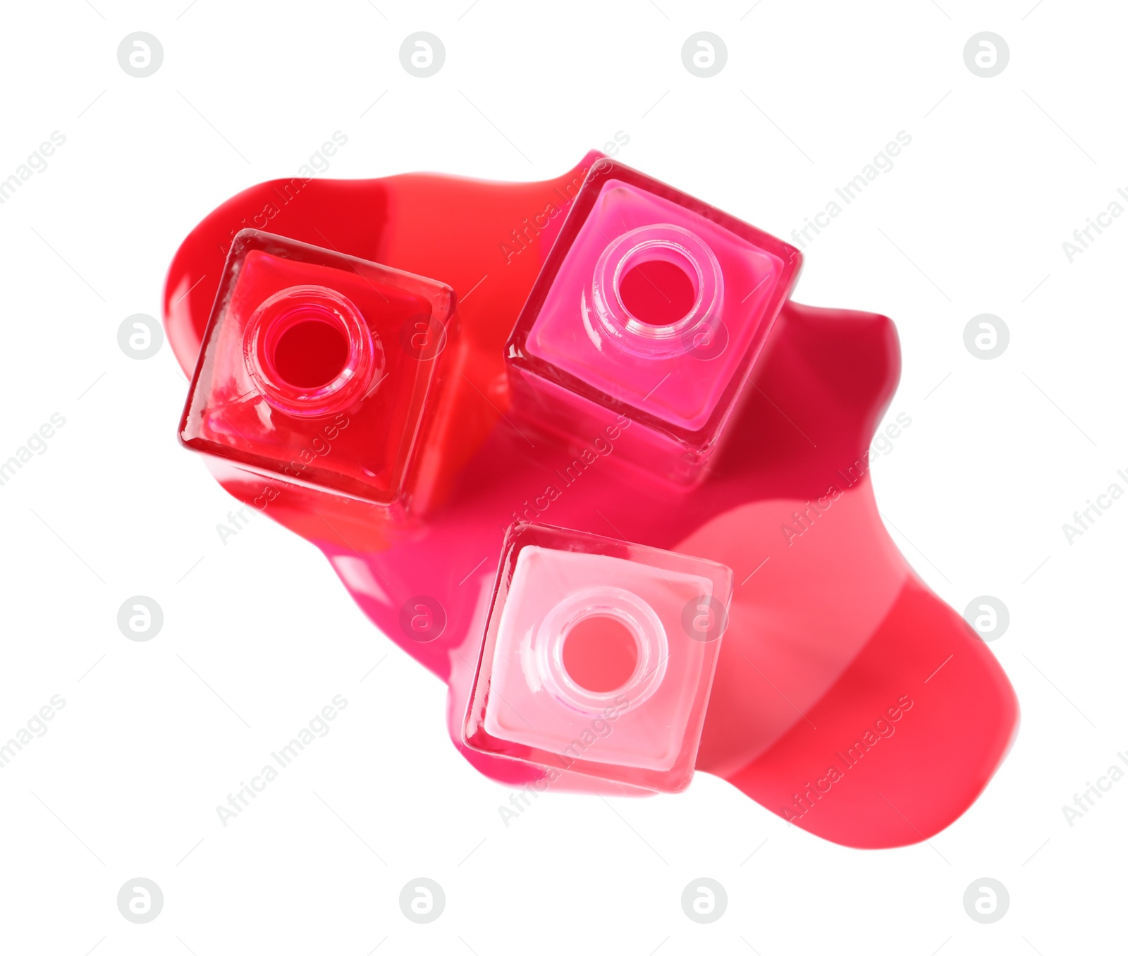 Photo of Spilled different nail polishes with bottles on white background, top view