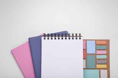 Photo of Monthly planners and stationery on white background, flat lay