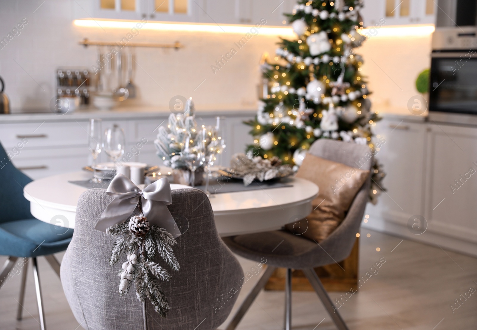 Photo of Grey chair with beautiful Christmas decor in kitchen. Interior design