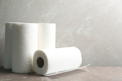 Photo of Rolls of paper towels on table, space for text