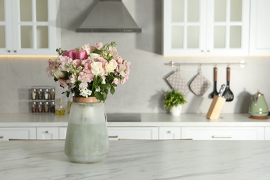 Photo of Beautiful bouquet of fresh flowers in vase on table indoors, space for text