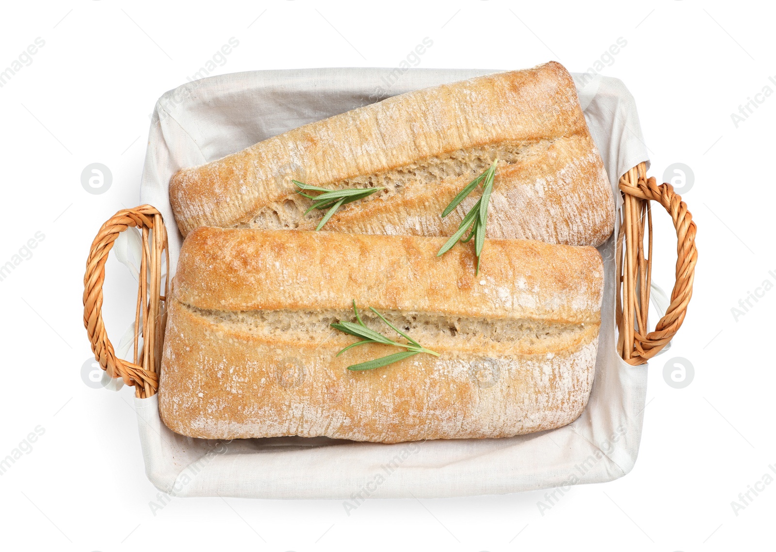 Photo of Crispy ciabattas with rosemary in wicker basket isolated on white, top view. Fresh bread