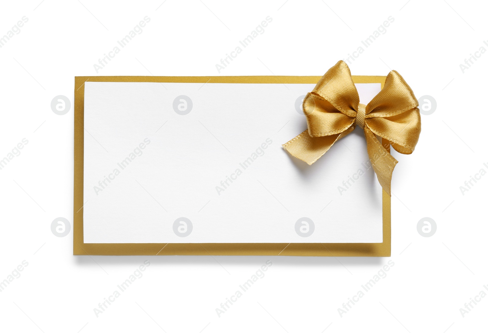 Photo of Blank gift card with golden bow isolated on white, top view