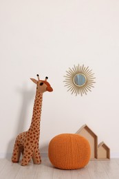 Photo of Beautiful children's room with light wall and toys. Interior design