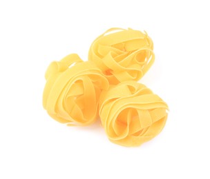 Raw fettuccine pasta isolated on white, top view