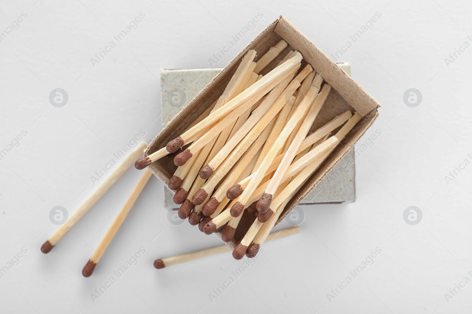 Photo of Cardboard box with matches on white background, top view