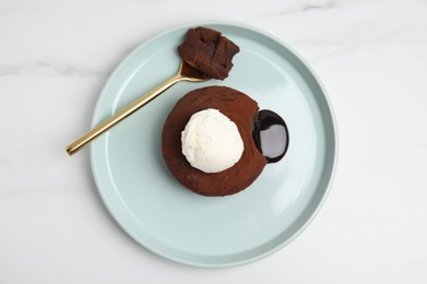 Photo of Delicious fresh fondant with hot chocolate and ice cream on white marble table, top view