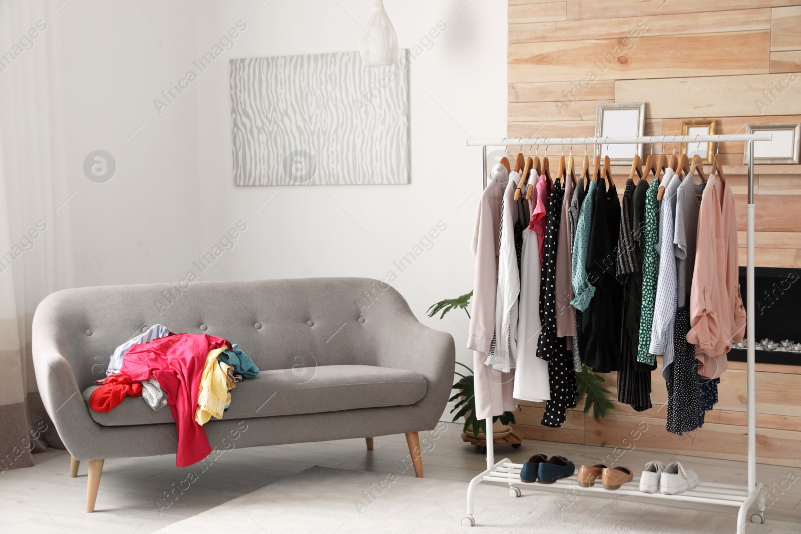 Photo of Mess in dressing room with sofa. Renew wardrobe